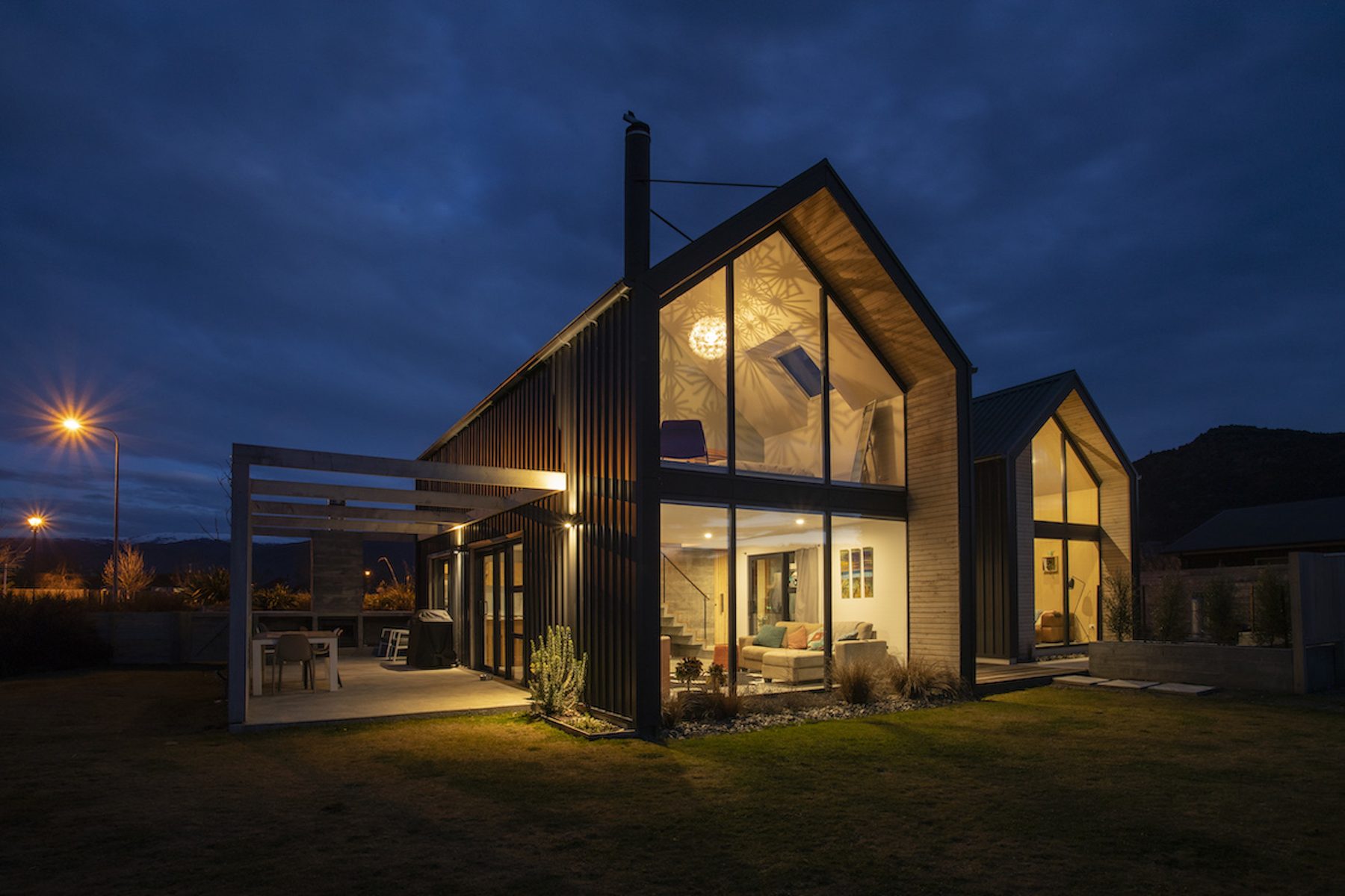 Smith House, dusk gable exterior with glowing interior